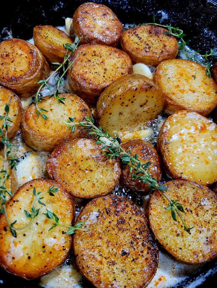 These roasted new potatoes with thyme and garlic are fantastic when made with freshly dug small potatoes. It's a perfect side dish for early summer meals and an easy recipe to prepare.
