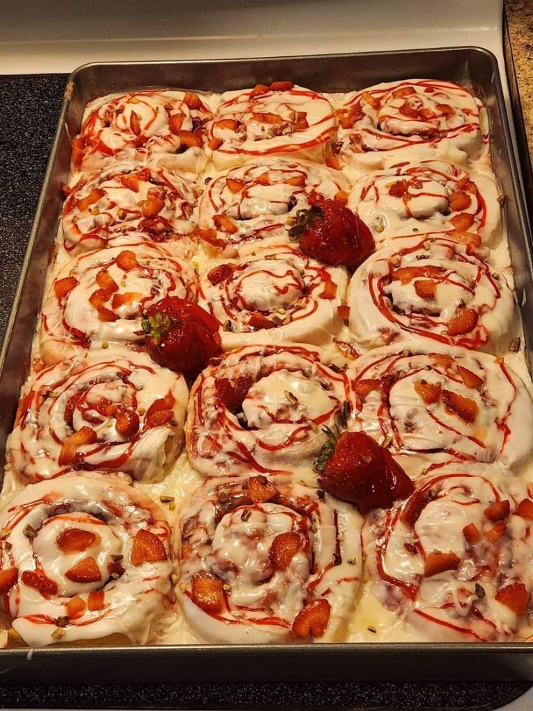 "Strawberry Cheesecake Cinnamon Rolls with Pecans - A delightful swirl of sweetness, embodying the perfect blend of strawberries, cheesecake, and pecans."