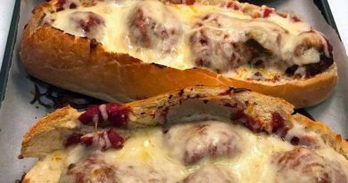 "Meatball Boats - Juicy ground beef meatballs on a bed of melted Asiago cheese in a perfectly hollowed hoagie roll, a gastronomic delight.