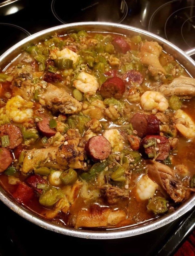 Bowl of okra stew with chicken, shrimp, and crawfish tails, served over rice