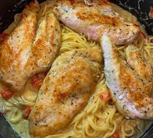 Italian Chicken Pasta: Juicy chicken, al dente spaghetti, and creamy Parmesan sauce on a white plate.