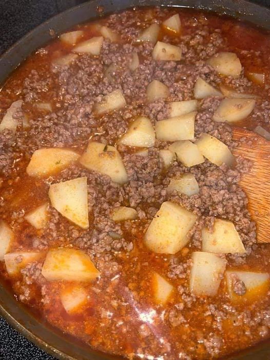 A plate of Picadillo Con Papa - ground beef and potatoes in a savory tomato sauce with spices and herbs