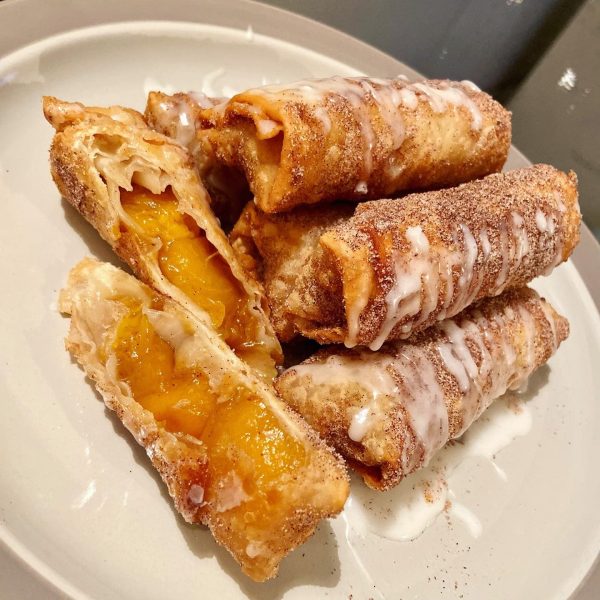 Peach cobbler filling wrapped in a crispy golden brown egg roll wrapper