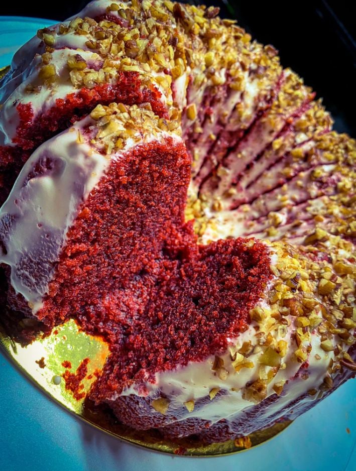 A slice of red velvet cake on a plate with a fork