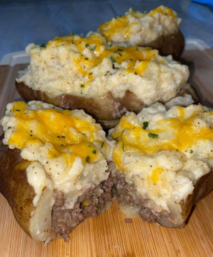 A baked potato filled with a flavorful shepherd's pie filling and topped with cheese.