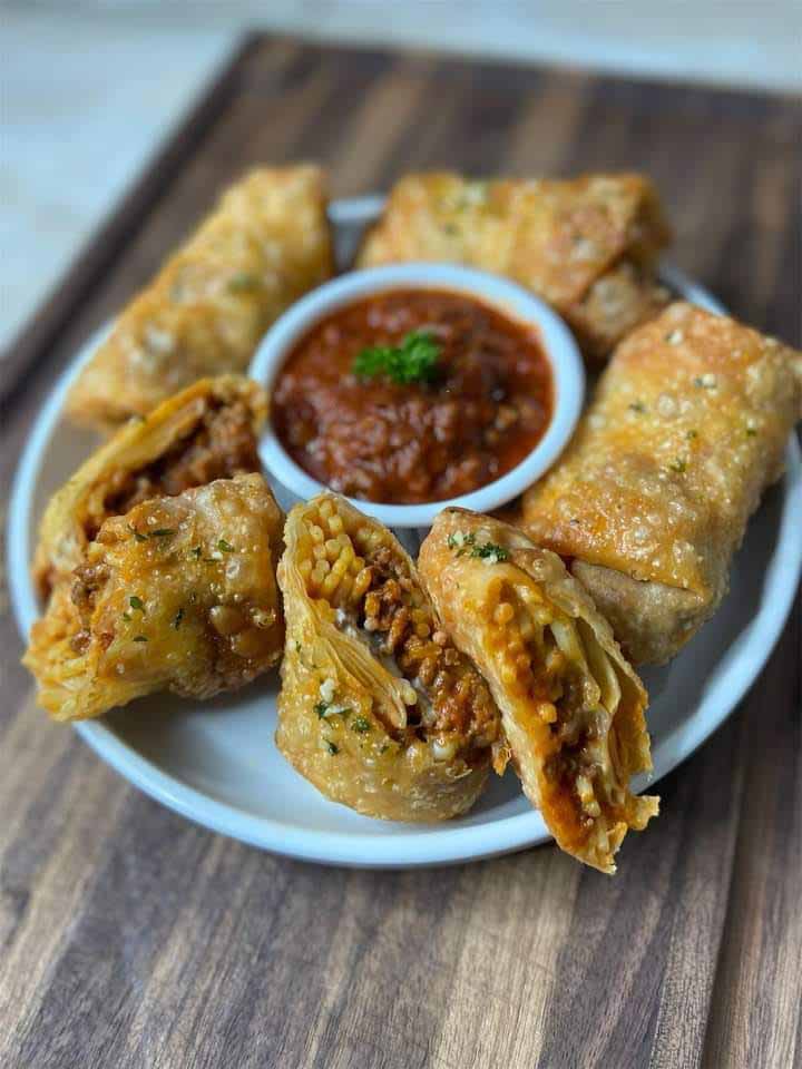 Image of golden brown spaghetti egg rolls on a plate, ready to be served