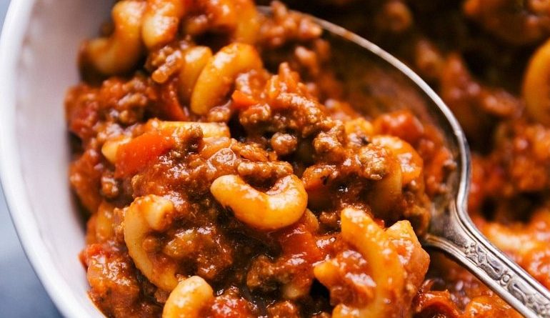 "Creamy and Cheesy Beef Goulash: A tempting bowl of goulash featuring succulent beef, aromatic spices, and a generous topping of melted cheese."