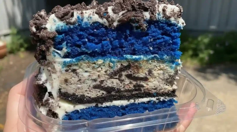 Closeup of a Blue Velvet Oreo Cheesecake Cake with Oreo crumbs on top