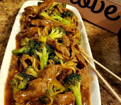 Sliced steak and broccoli stir-fry in a wok, showcasing the delicious Beef and Broccoli recipe."