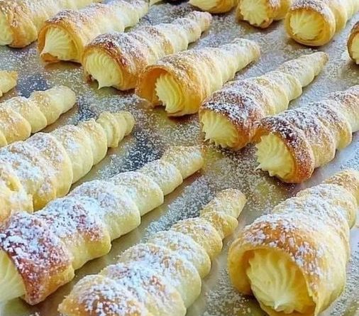 "Puff Pastry Cream Horns - Golden pastry cones filled with velvety custard, a delectable dessert treat."