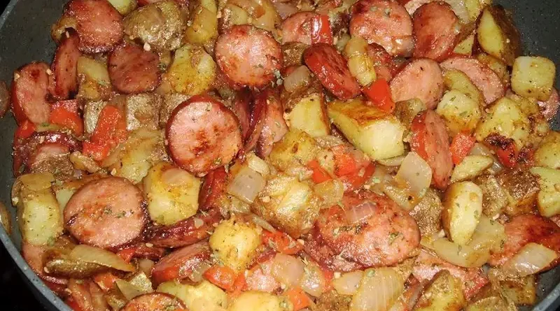 "Skillet Potatoes Recipe: A medley of russet potatoes, smoked sausage, and vegetables in a sizzling pan, showcasing culinary excellence."