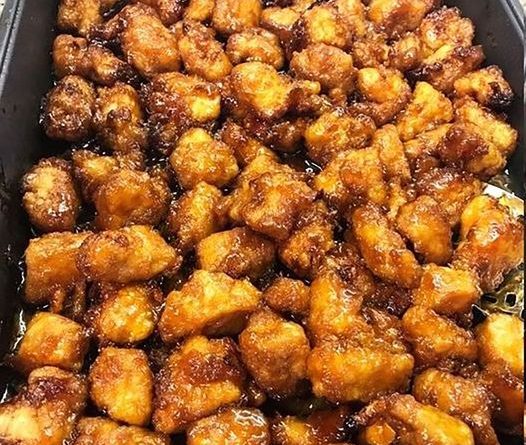 Baked Sweet and Sour Chicken - Crispy chicken pieces coated in a flavorful sauce, served with rice