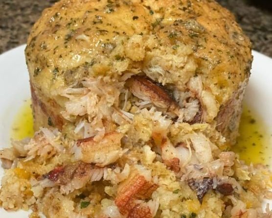 Crab Stuffed Cheddar Bay Biscuit showcased with a golden-brown crust, filled with lump crab, and drizzled with Garlic Lemon Butter.