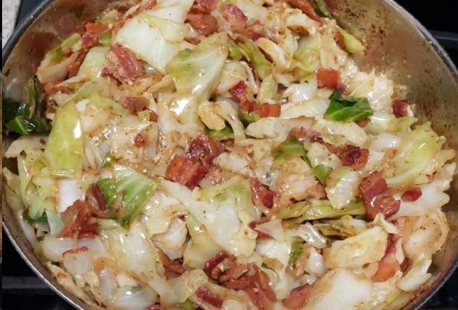 Sizzling bacon crumbles atop a bed of perfectly cooked cabbage in our signature Fried Cabbage recipe.