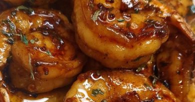 "Henny Butter Shrimp: A plate of succulent shrimp bathed in a rich Hennessy-infused sauce, garnished with fresh parsley."