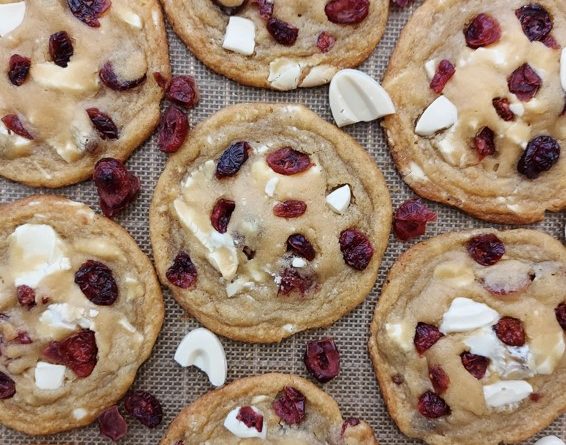 Premium white chocolate cranberry cookies on a baking sheet, showcasing the perfect blend of sweetness and tartness.