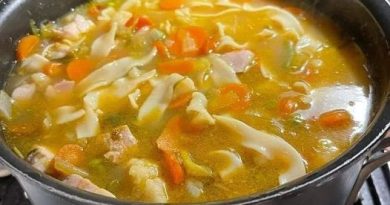 Steaming bowl of homemade chicken noodle soup - a comforting culinary delight.