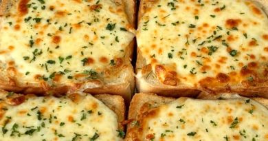 Cheesy Texas Toast with garlic-infused butter, cheddar, Monterey Jack, and Parmesan cheese, oregano, and basil, toasted to golden perfection.