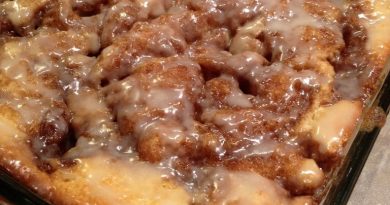 Cinna-Bun Cake displayed on a white plate, topped with a generous layer of cinnamon-infused goodness.