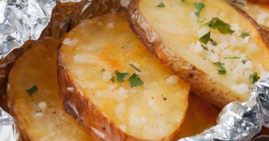 Grilled potato packets on a barbecue grill, seasoned to perfection