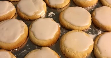 A close-up photo of almond meltaway cookies on a cooling rack. The cookies are light and airy, with a sprinkle of sliced almonds on top.
