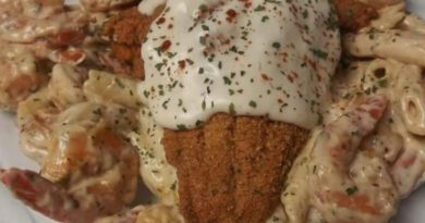 A bubbling hot casserole dish filled with tender catfish, plump shrimp, and cavatappi pasta in a creamy white alfredo sauce.