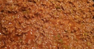 A close-up photo of a hamburger bun overflowing with a savory Sloppy Joe mixture made with ground beef, peppers, onions, and salsa.