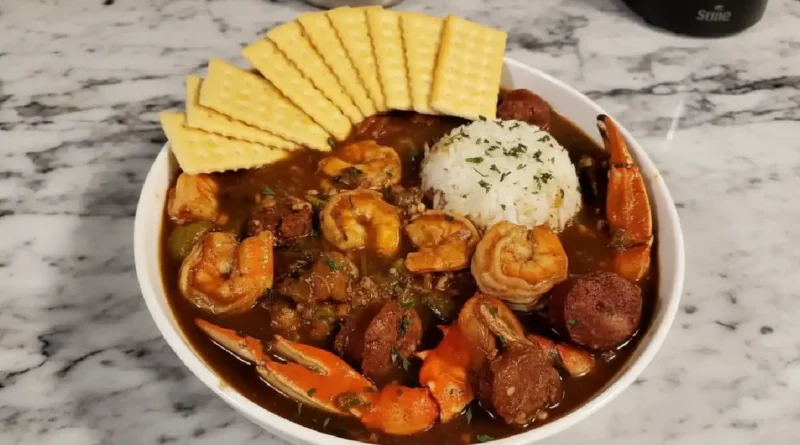 Seafood Gumbo Recipe - A medley of shrimp, crab, crawfish, and Andouille sausage in a rich broth, served over steamed rice.