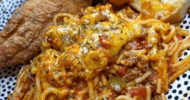 Fried catfish fillets served over spaghetti with tomato sauce