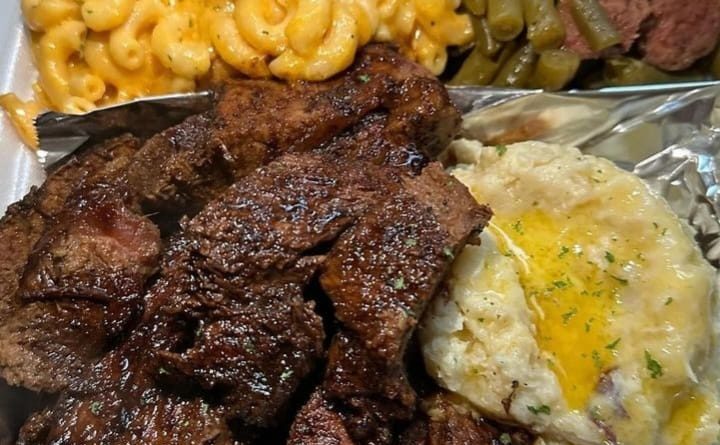 Juicy steak being basted with garlic thyme butter in a cast-iron skillet