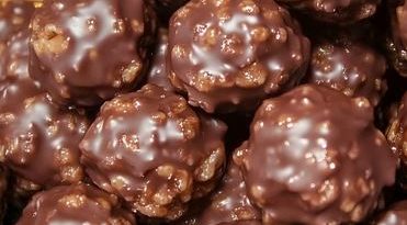 Chocolate Rice Krispie Balls - A plate filled with chocolate-covered rice krispie balls.