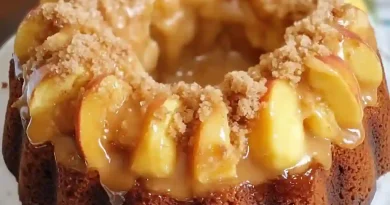 Peach Cobbler Pound Cake - A visual delight showcasing layers of cream cheese, fresh peaches, and a drizzling glaze on a bundt pan