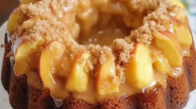 Peach Cobbler Pound Cake - A visual delight showcasing layers of cream cheese, fresh peaches, and a drizzling glaze on a bundt pan