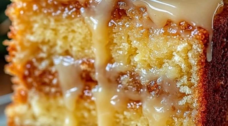 A perfectly frosted Pineapple Heaven Cake topped with fresh pineapple slices and coconut shreds.