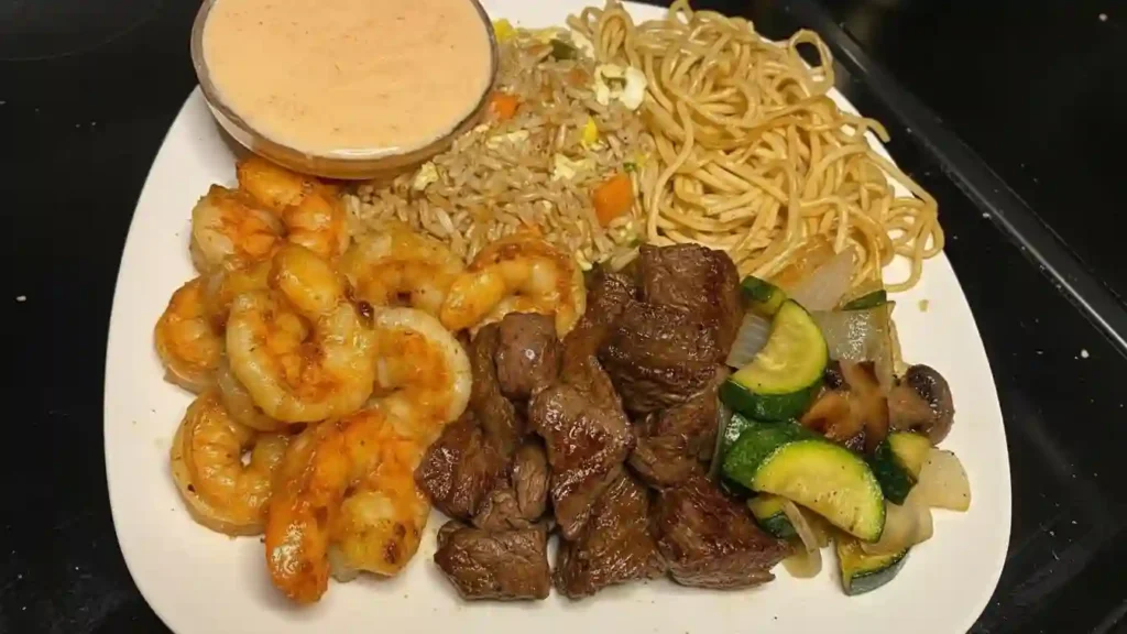 Close-up of a bowl of homemade hibachi with chicken, onions, and bell peppers