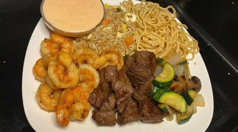 Close-up of a bowl of homemade hibachi with chicken, onions, and bell peppers