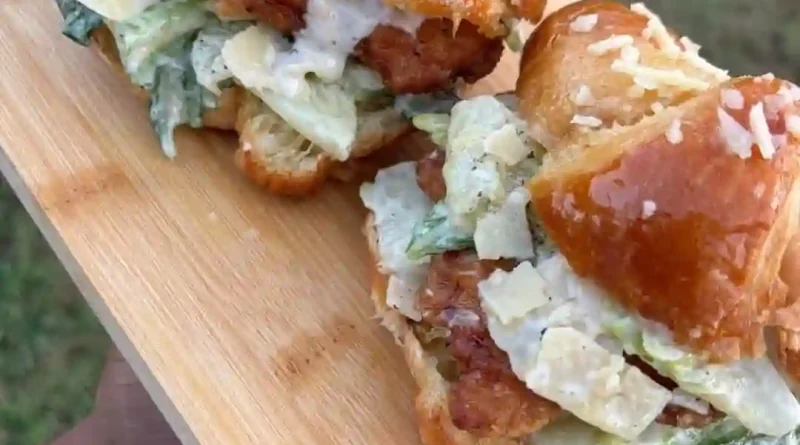 Chicken Caesar Croissant Sandwich Recipe A Delicious and Easy-to-Make Sandwich Looking for a satisfying yet effortless meal? This Chicken Caesar Croissant Sandwich is the perfect combination of rich flavors and flaky goodness. With creamy Caesar dressing, tender chicken, and buttery croissants, it’s a must-try recipe! Ingredients You’ll Need To create this mouthwatering sandwich, gather the following ingredients: 2 cups cooked and shredded chicken ½ cup Caesar dressing ¼ cup grated Parmesan cheese 1 teaspoon lemon juice ½ teaspoon black pepper ½ teaspoon garlic powder 1 cup romaine lettuce, chopped 4 buttery croissants, sliced in half ½ cup cherry tomatoes, sliced (optional) Step-by-Step Instructions 1. Prepare the Chicken Filling In a large bowl, mix the shredded chicken with Caesar dressing, Parmesan cheese, lemon juice, black pepper, and garlic powder. Stir well to coat the chicken evenly with creamy goodness. 2. Assemble the Sandwich Slice the croissants in half and place a generous amount of the Caesar chicken mixture onto the bottom halves. Top with fresh romaine lettuce and cherry tomato slices for a refreshing crunch. 3. Serve and Enjoy Cover with the other half of the croissant, press lightly, and serve immediately. Pair with crispy chips, a side salad, or fresh fruit for a complete meal. Why You’ll Love This Recipe Quick and Easy: Perfect for busy days when you need a tasty meal fast. Rich in Flavor: The combination of Caesar dressing and buttery croissants is irresistible. Great for Any Occasion: Whether it’s lunch, brunch, or a light dinner, this sandwich is always a hit! Customization Ideas Want to switch it up? Try these variations: Add Bacon: Crispy bacon adds an extra savory crunch. Spice It Up: A pinch of red pepper flakes gives it a kick. Use Different Bread: Swap croissants for ciabatta or a whole wheat roll for a healthier twist. Final Thoughts chicken Caesar Croissant sandwich
