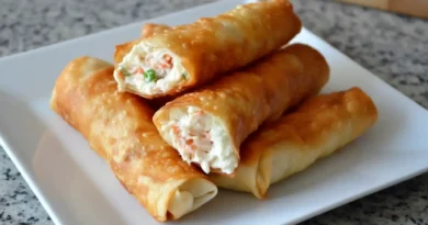 Crispy Crab Rangoon Egg Rolls filled with fresh crab, cream cheese, and spices – a golden delight for your taste buds.