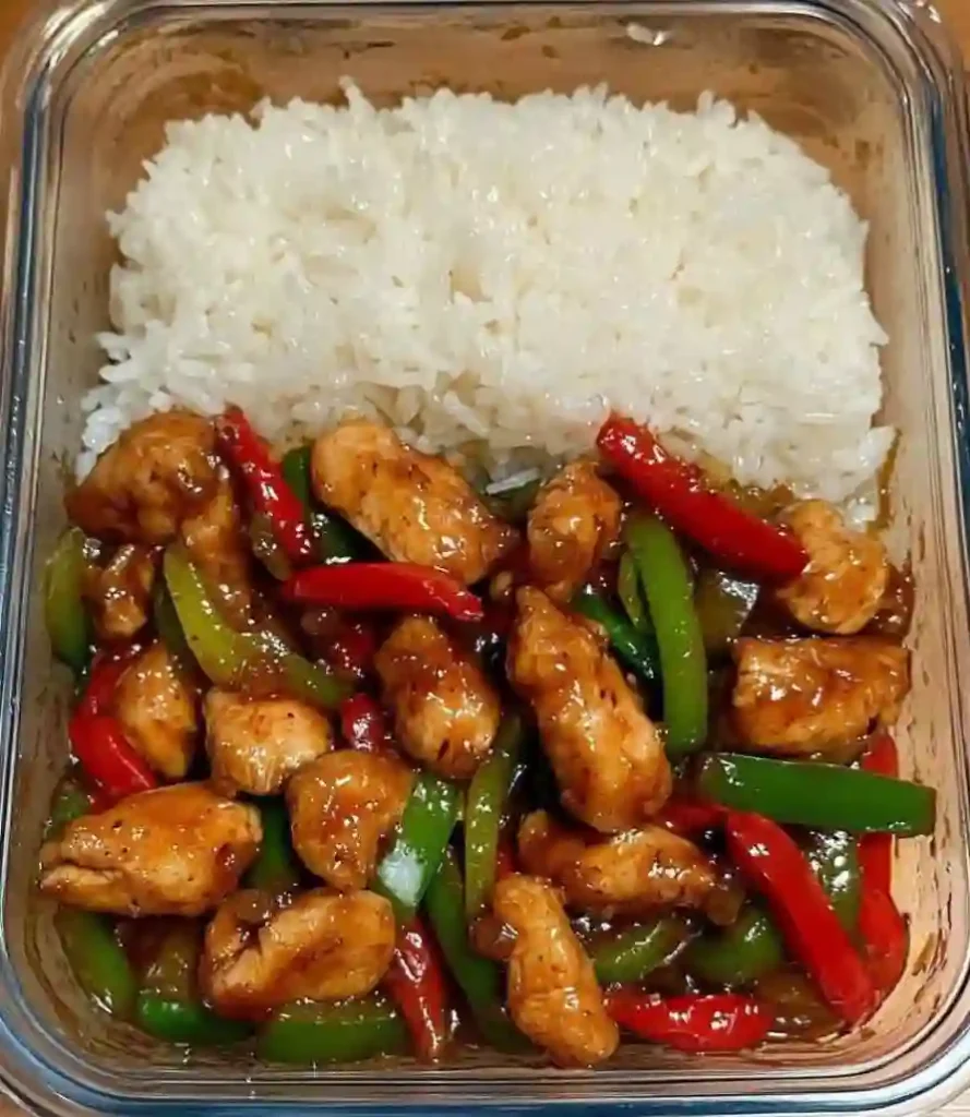 Sizzling garlic chicken stir fry with peppers and steamed rice