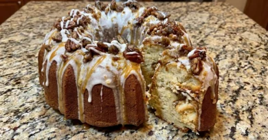 Peach Cobbler Pound Cake - A visual delight showcasing layers of cream cheese, fresh peaches, and a drizzling glaze on a bundt pan